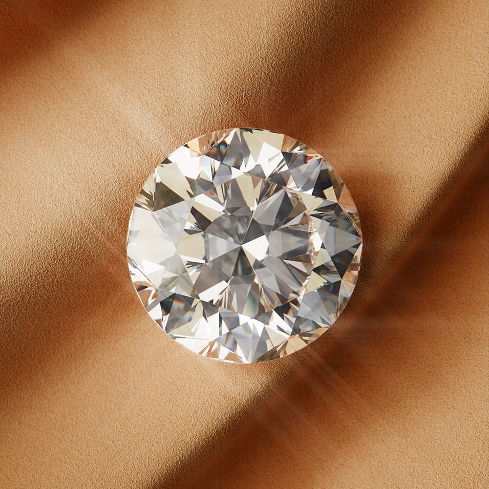 A sparkling round diamond resting on a soft, warm-toned fabric, showcasing Goldsmiths Signature diamond precision-cut facets.